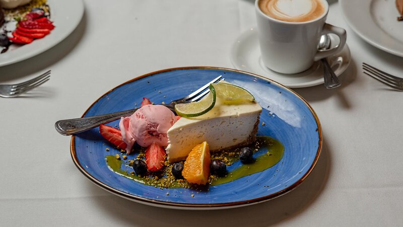 Key lime pie dessert with strawberry ice cream and fruit