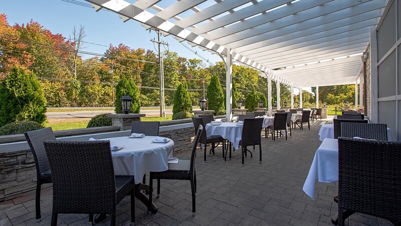 Outside dining area with many set tables