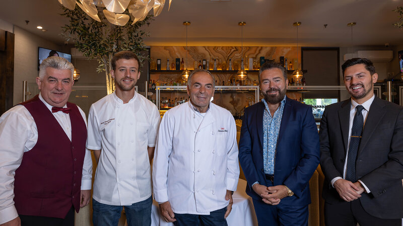 Five of Barka's staff including waiter, chefs and owners standing side-by-side